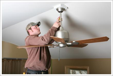 Electrician installing ceiling fan